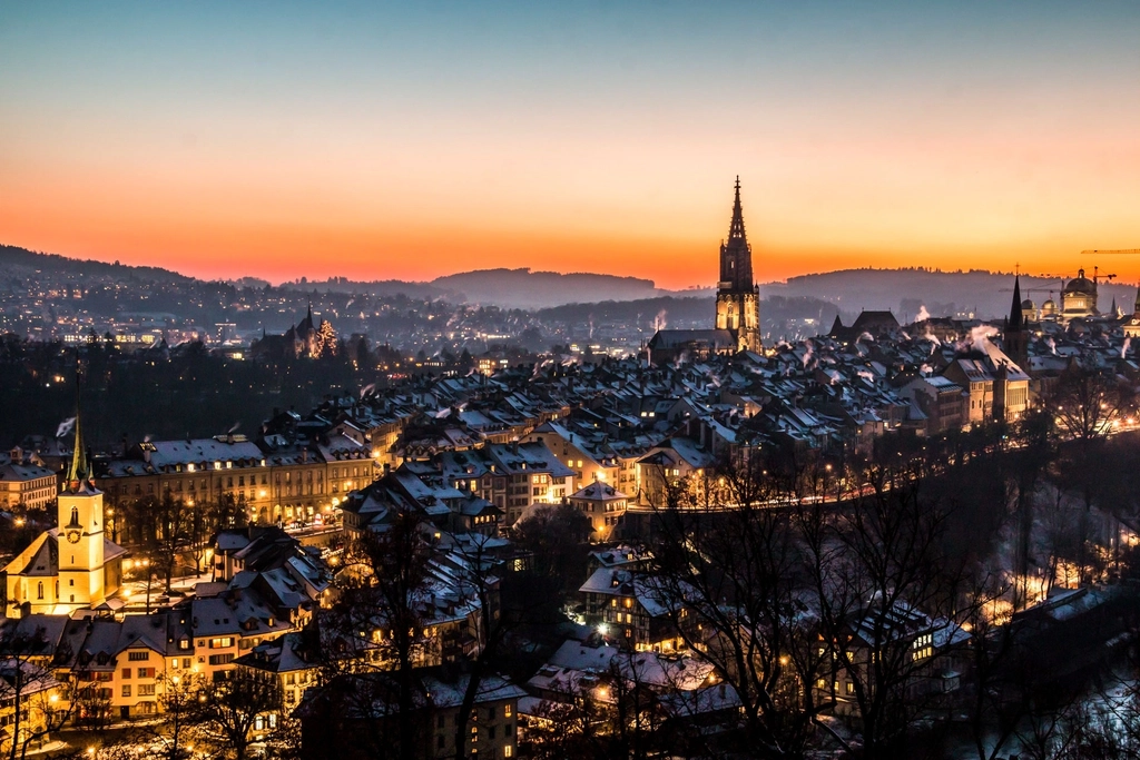 European city skyline at night with illuminated office buildings